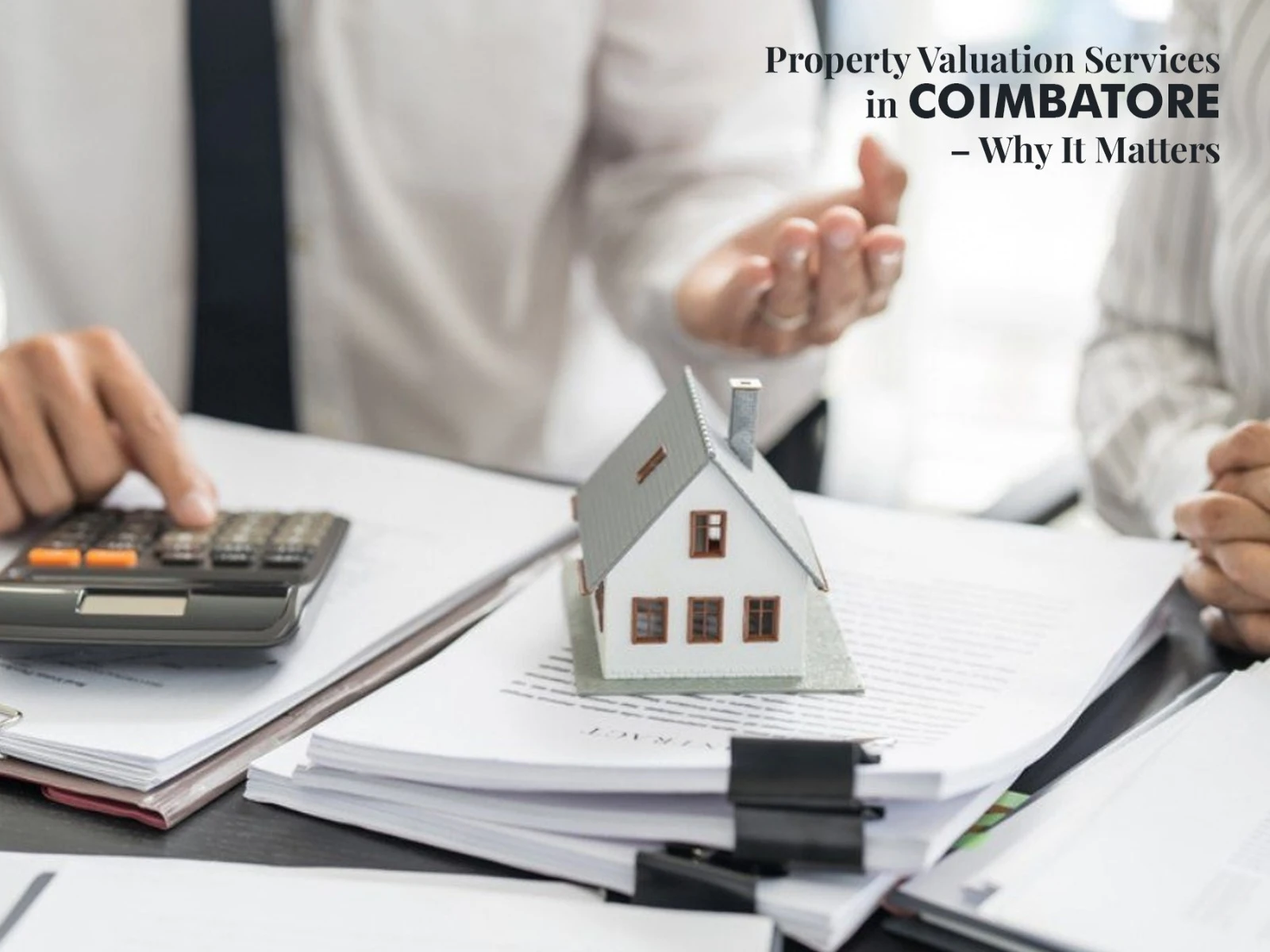 Property valuation consultation with experts reviewing documents and assessing real estate value in Coimbatore.